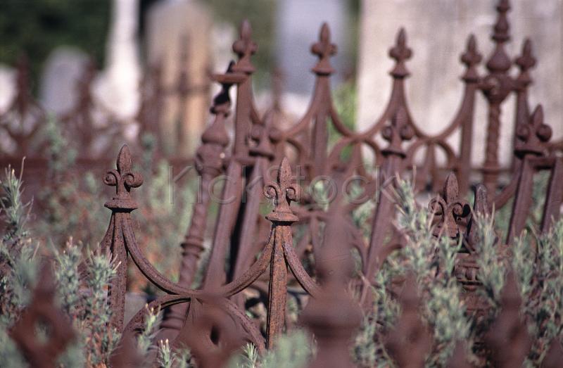 rusted cast iron railings and headstones
