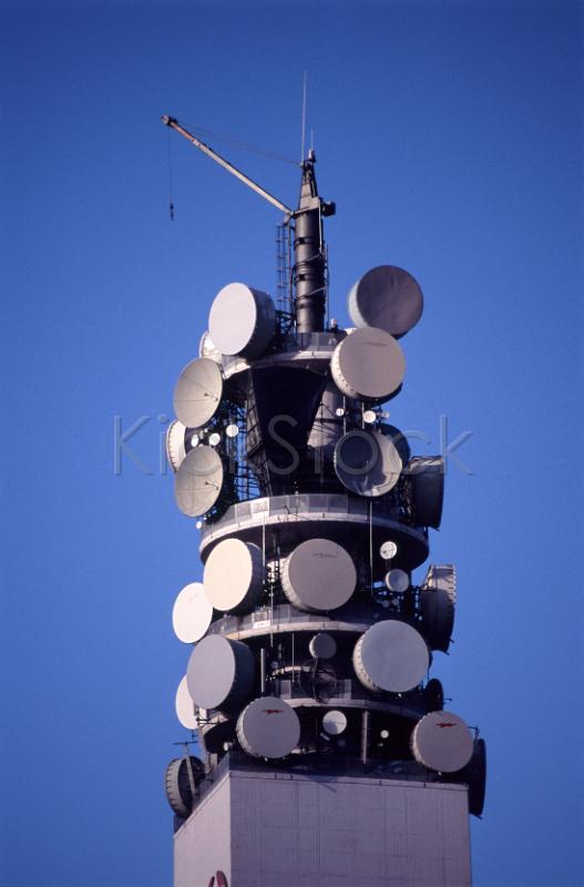 top of a communications tower with many microwave dishes