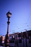 an old street lamp and a passing tram in melbourne, australia