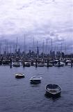 marina yachts and three small tenders, melbourne buildings in the background